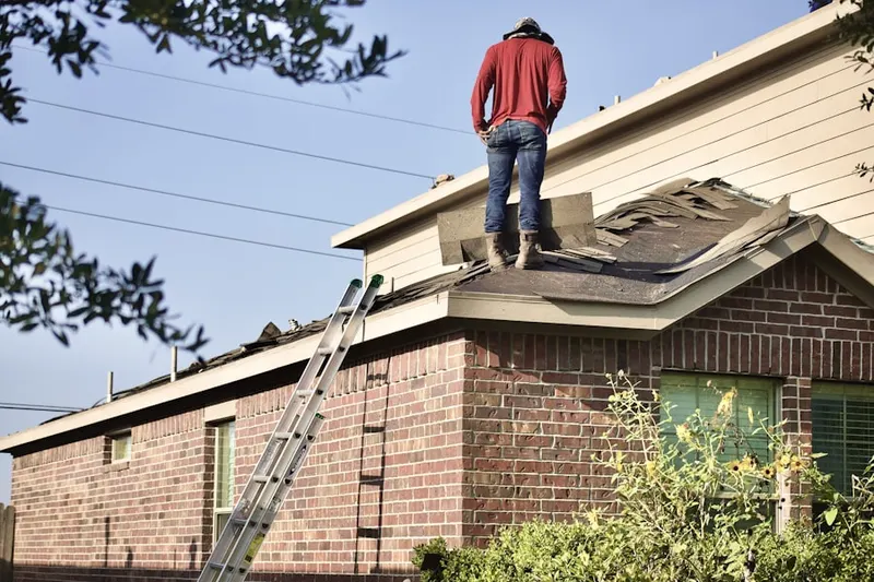 Professional roofer working on a residential roof in Bloomsdorf